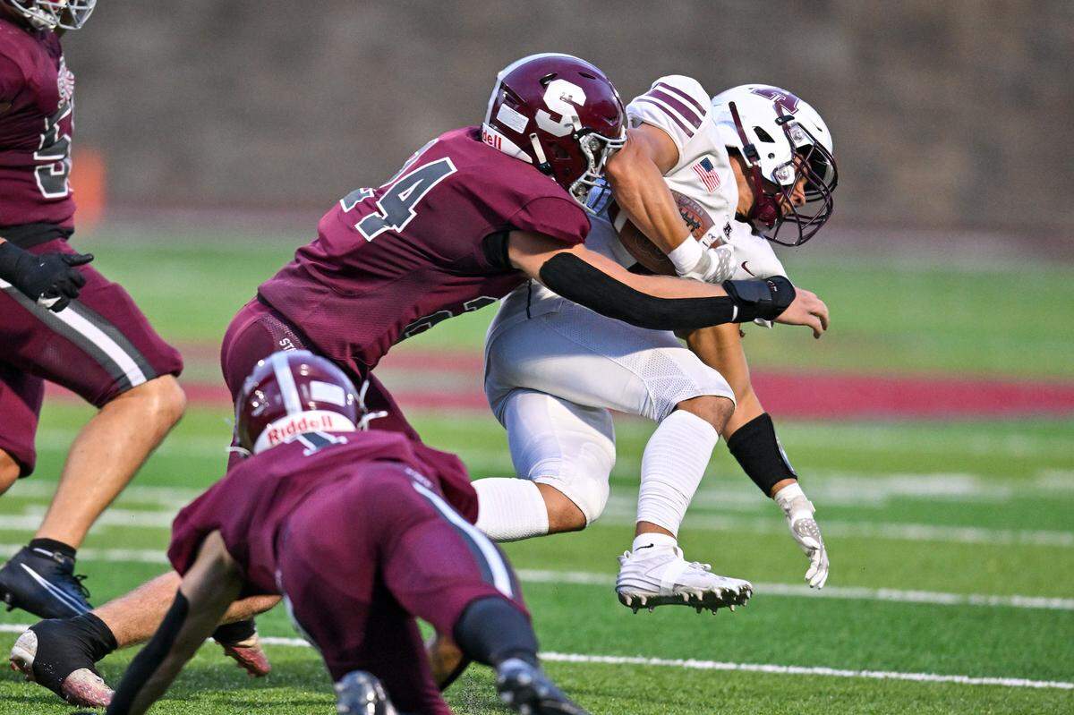 State College’s Trayce Brennan makes a tackle on an Altoona player in their home opener on Friday, Aug. 30, 2024.