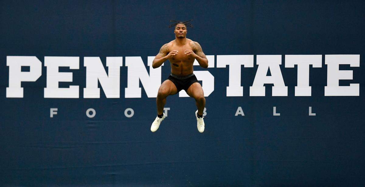 Safety Jaquan Brisker leaps in the air to warm up for the 40 yard dash during Penn State pro day on Thursday, March 24, 2022 in Holuba Hall.