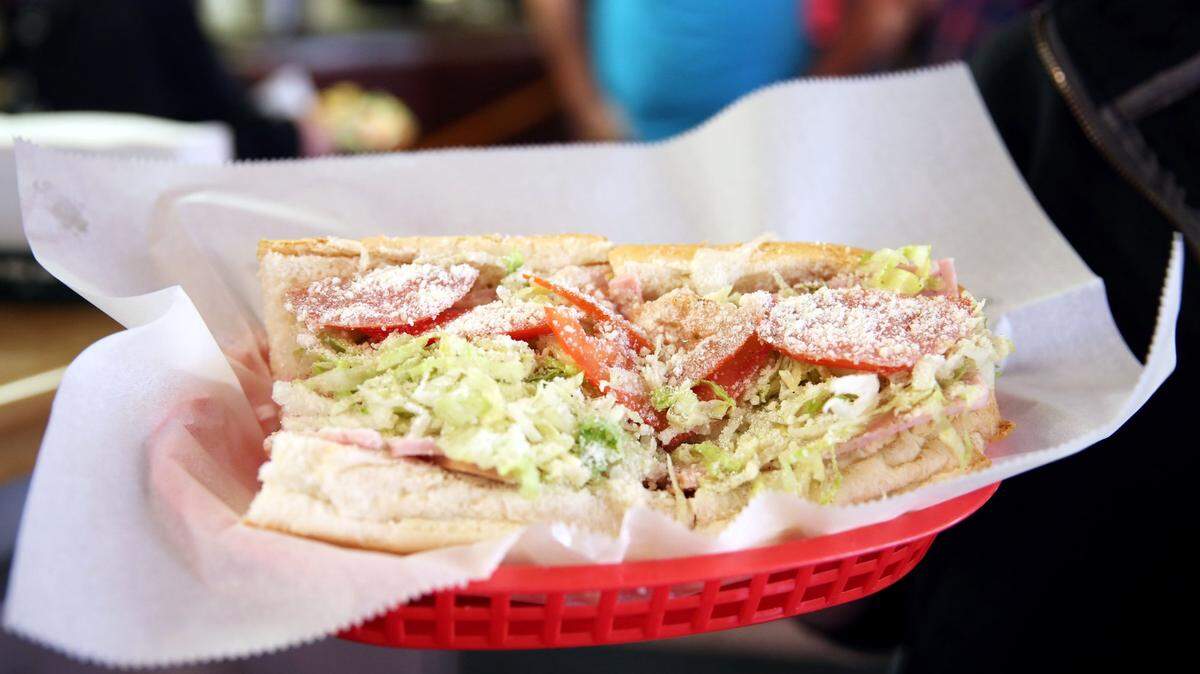 Paige Boscaino holds an Italian hoagie in May 2017 at Jim’s Italian Cuisine in Bellefonte.