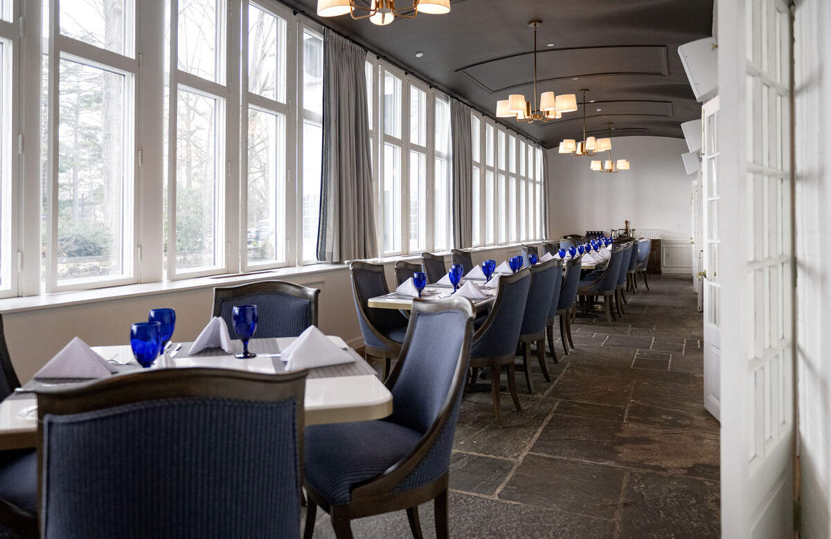 A dining space at the Nittany Lion Inn that features original woodwork, barrel ceiling and unique flooring.