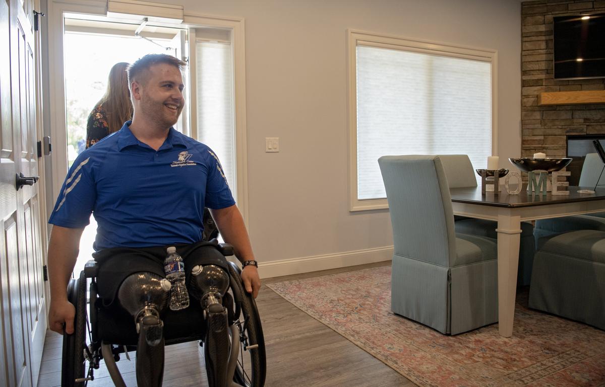 Army Sgt Adam Hartswick sees the inside of his brand new smart home from the Stephen Siller Tunnel to Towers Foundation for the first on Wednesday, Sept. 11, 2019.