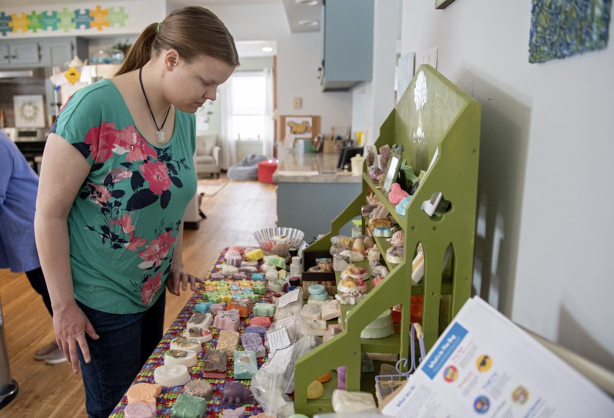 Mary Krupa looks at the soaps she and others at the ACRES Project have made through Acres of Joy. The group is hoping to expand to include an aquaponics system and Community Supported Agriculture program.