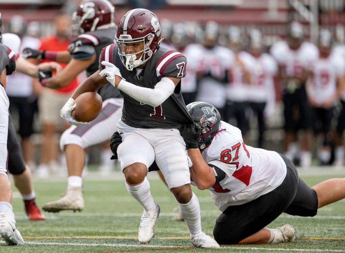 Williamsport’s Austin Best tries to stop State College’s D’antae Sheffey during the game on Friday, Aug. 26, 2022 at Memorial Field.