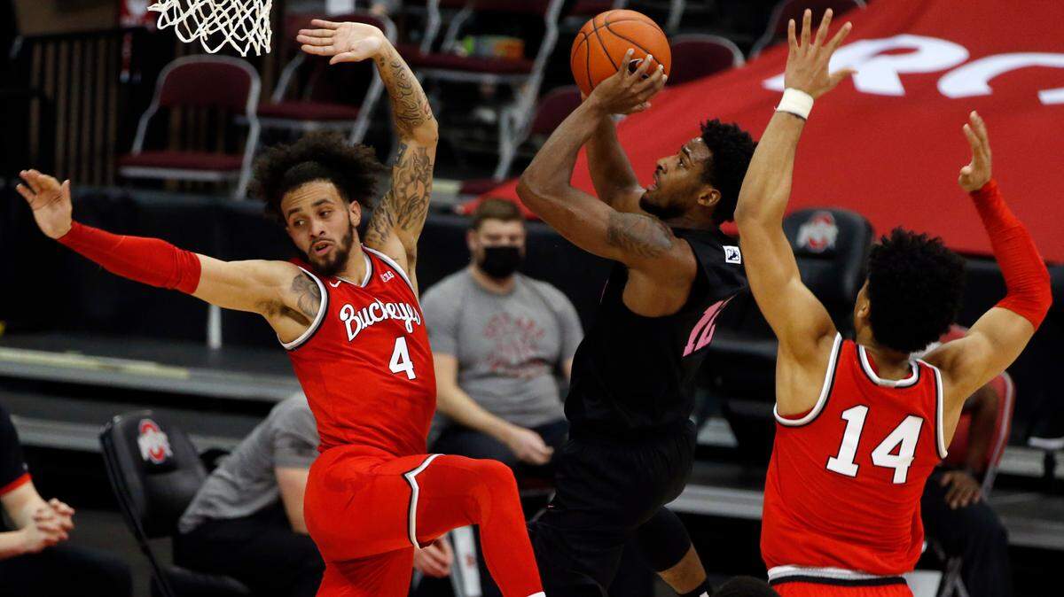 Penn State’s Izaiah Brockington, center, shoots between Ohio State’s Duane Washington, left, and Justice Sueing during the first half of an NCAA college basketball game Wednesday, Jan. 27, 2021, in Columbus, Ohio. (AP Photo/Jay LaPrete)