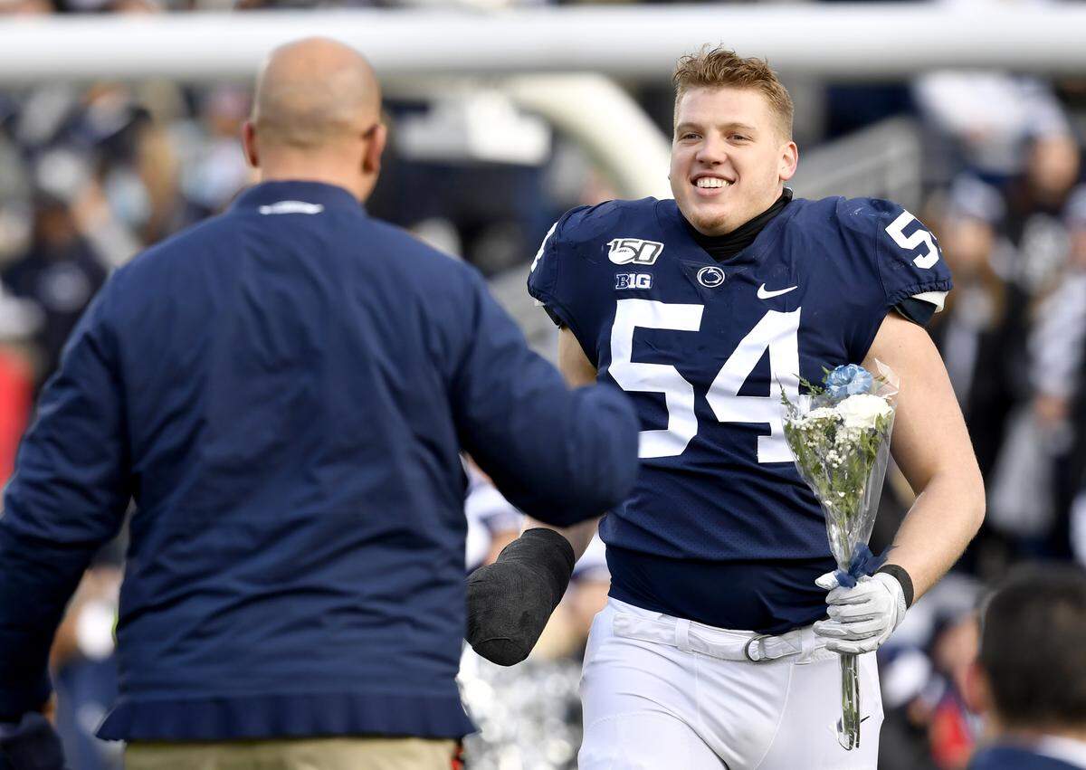 Penn State defensive tackle Robert Windsor smiles as he runs to hug coach James Franklin during the senior day celebration before the game against Rutgers on Saturday, Nov. 30, 2019.