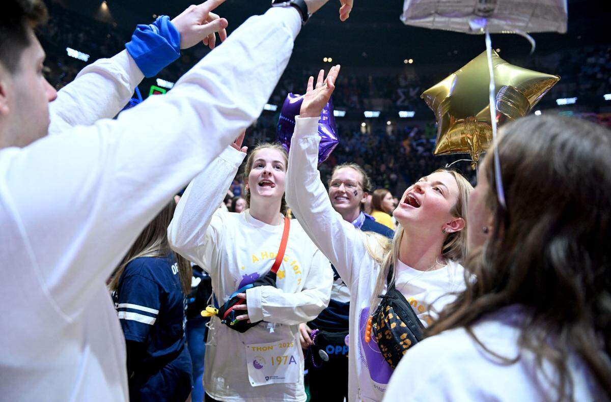 Dancers celebrate standing up to start the 46-hour Penn State dance marathon on Friday, Feb. 21, 2025.