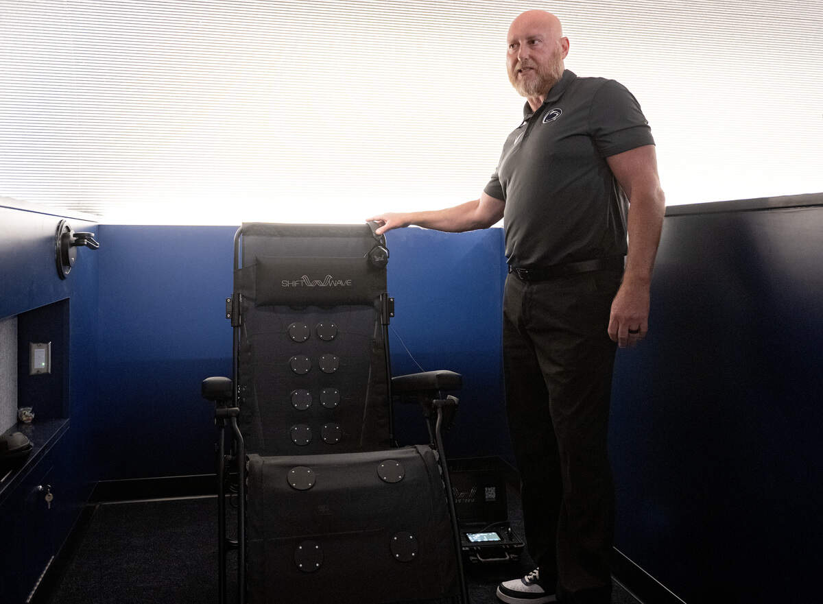 Penn State chief performance officer Jeremy Scott talks about one of the shiftwave chairs available to athletes in the Greenberg Indoor Sports Complex Tuesday, Aug. 19, 2025.  