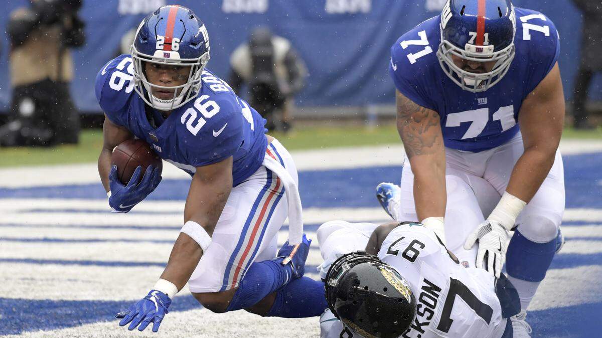 Jacksonville Jaguars defensive tackle Malik Jackson (97) tackles New York Giants’ Saquon Barkley (26) during the first half of an NFL football game Sunday, Sept. 9, 2018, in East Rutherford, N.J. (AP Photo/Bill Kostroun)