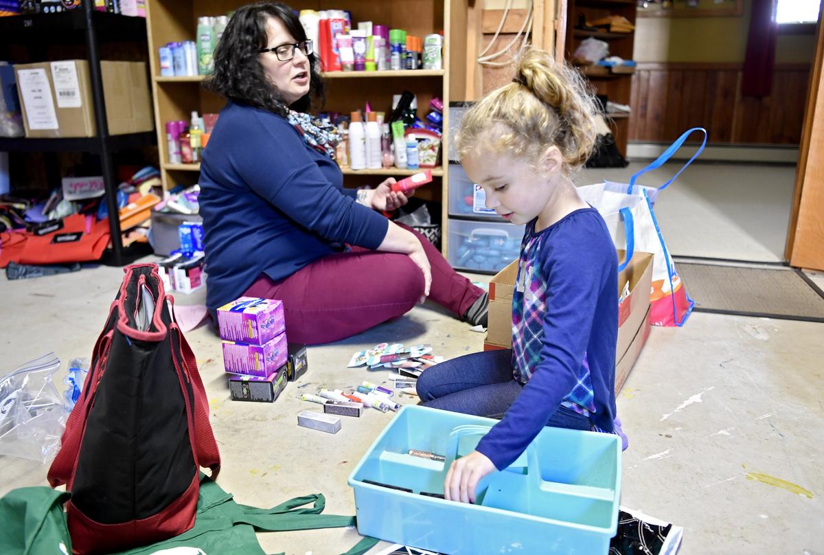 Raylynn Cassick, 6, helps to sort through donations for Little Bag of Sunshine on Tuesday, Oct. 8, 2019. The organization sends bags of hygiene products home with students in need.