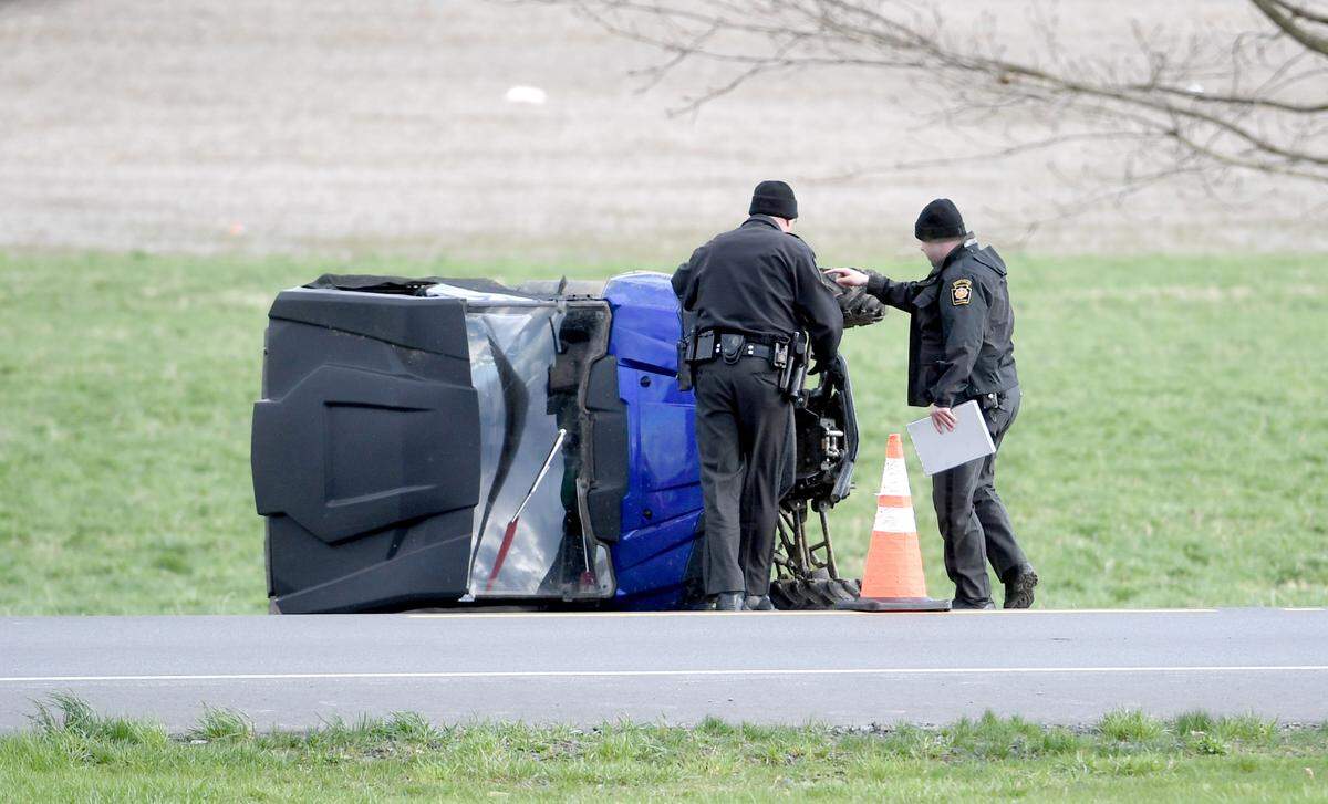 Pennsylvania State Police troopers look at the all-terrain vehicle that was involved in a crash with another vehicle on Route 64 on Tuesday.