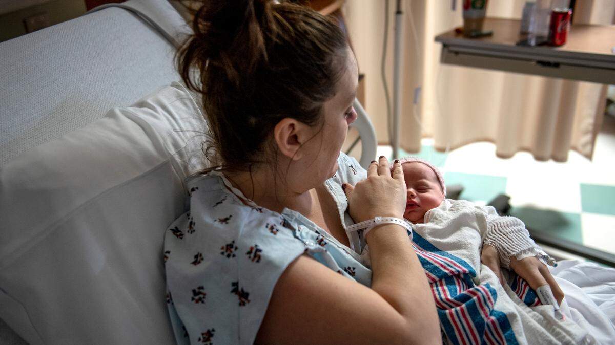 Breeanne Schreffler touches her newborn baby, Cayzlee Walter, who was the first baby born in 2019 at Mount Nittany Hospital.
