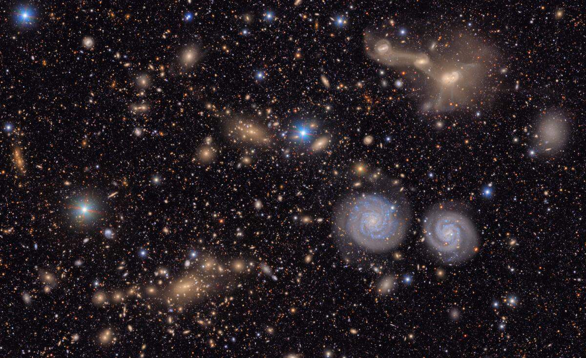 This image captures a small section of NSF–DOE Vera C. Rubin Observatory’s view of the Virgo Cluster, offering a vivid glimpse of the variety in the cosmos. Visible are two prominent spiral galaxies, three merging galaxies, galaxy groups both near and distant, stars within the Milky Way, and much more.