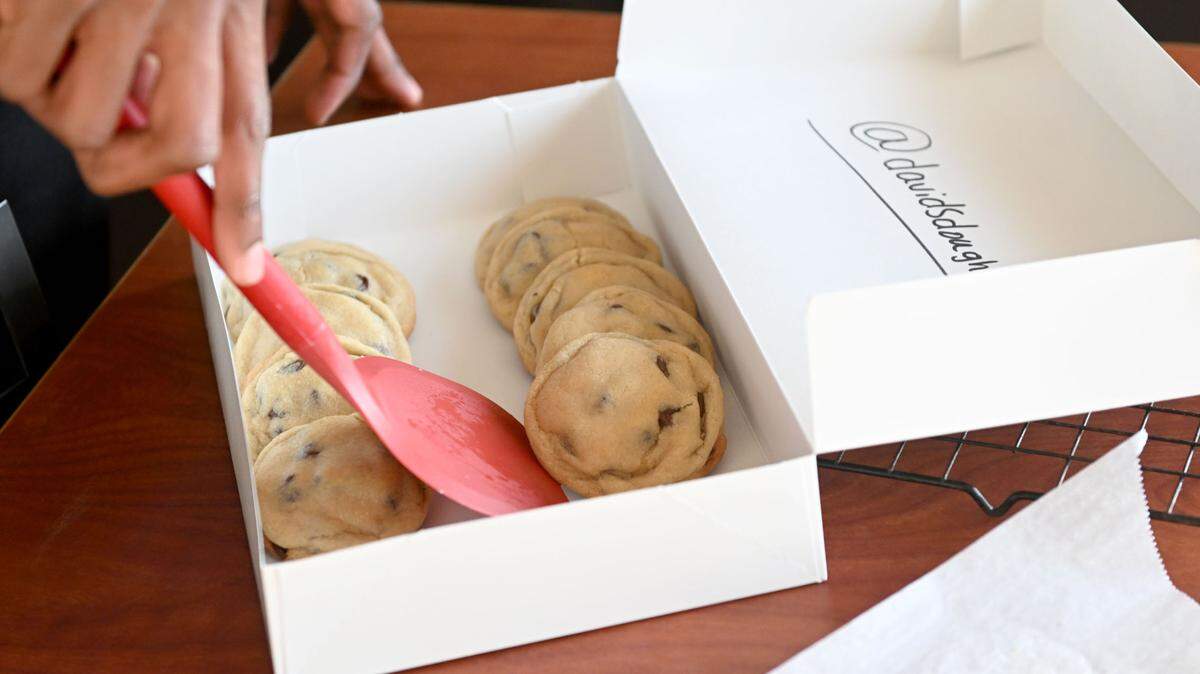 David Hayes packages a box of chocolate chip cookies on Monday, Nov. 13, 2023.