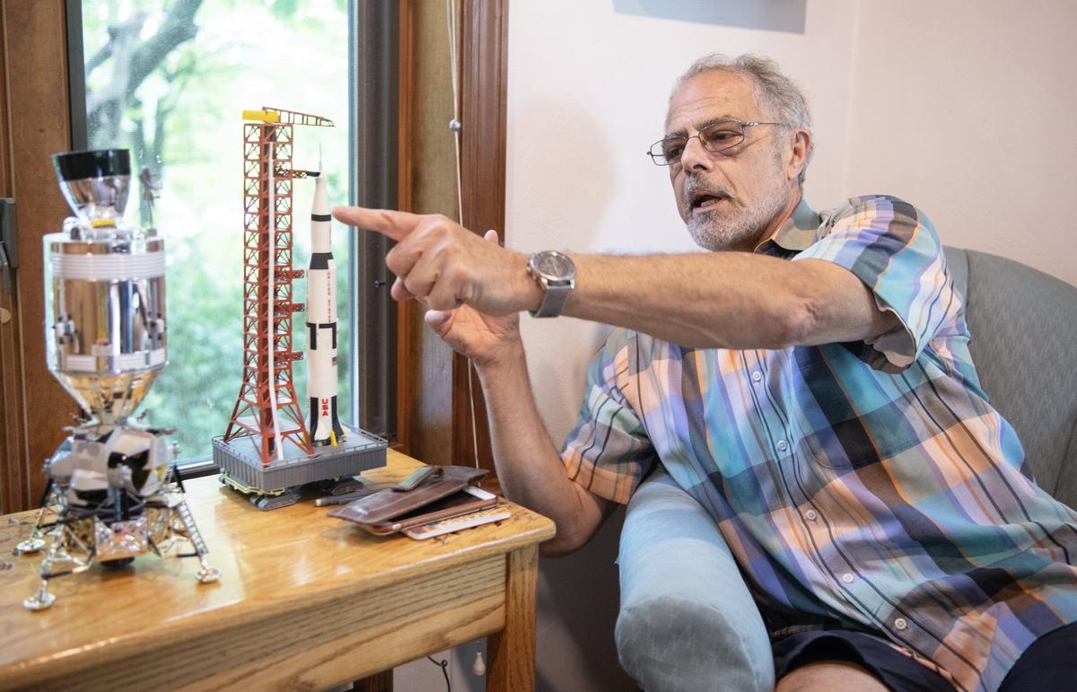 Denny Gioia talks about the different sections of the Saturn V rocket from the Apollo 11 mission on a model in his home on July 8. Gioia started his engineering career working in Cape Canaveral with the Apollo 11 team.