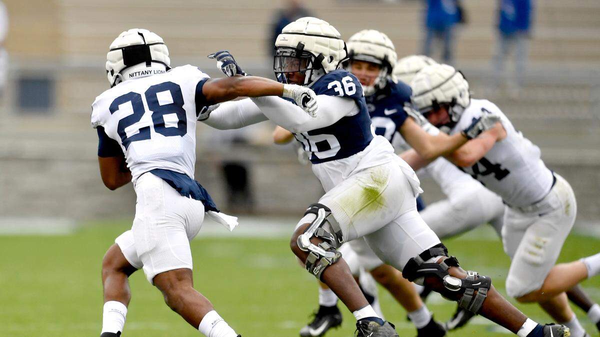Penn State defensive end Zuriah Fisher tries to stop running back Devyn Ford during spring practice on Saturday, April 17, 2021, at Beaver Stadium.