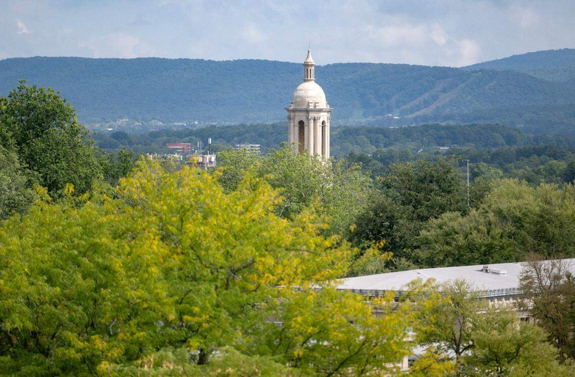 The bell tower of Old Main sticks out above the trees on the Penn State campus on Monday, Sept. 12, 2022.