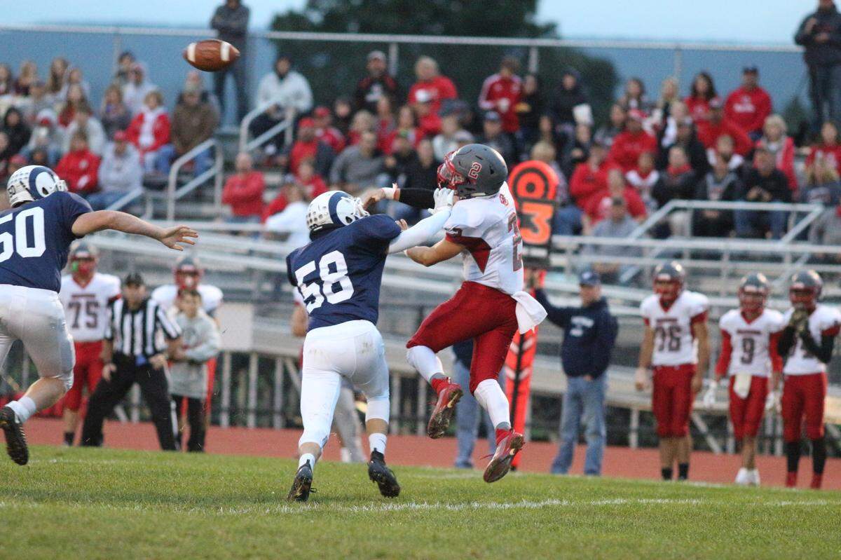 Penns Valley’s 58 Zach Royer pressures Central QB Jeff Hoenstine Friday evening inn Spring Mills.