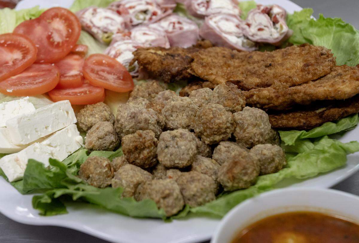 A sampler tray from Taste of Transylvania that includes Chiftele, which are Romanian meatballs, and Romanian chicken schnitzel on Tuesday, May 19, 2026. 