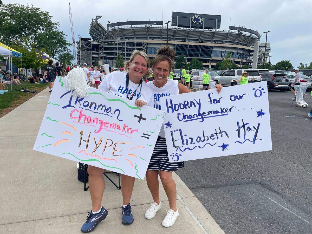 Beth Shaha and Jennifer Eisenhuth cheer on participants Sunday, June 14, 2026, near Beaver Stadium at the Ironman 70.3 Pennsylvania Happy Valley North American Championship in Centre and Clinton counties.