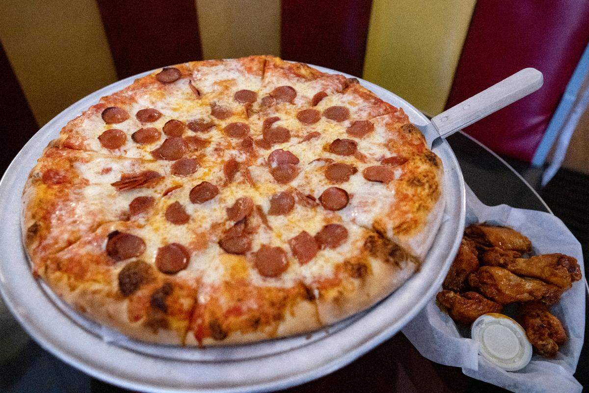 A pepperoni pizza and wings with Tim’s sauce at the Hofrbau in Bellefonte.