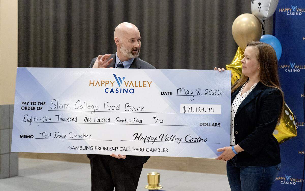 General manager of Happy Valley Casino Eric Pearson presents a check to a representative of the State College Food Bank during a ribbon cutting for the Happy Valley Casino on Friday, May 8, 2026. Money that was brought in on the test days of the casino were split between the YMCA of Centre County and the State College Food Bank.  