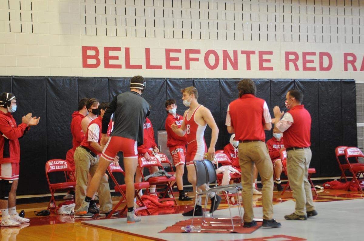 Bellefonte coaches and wrestlers congratulate Ethan Richner as he earned his 100th win on Saturday in the Red Raiders’ 54-15 win over Philipsburg-Osceola. Richner pinned the Mounties’ Jimmy Richtscheit in 23 seconds.