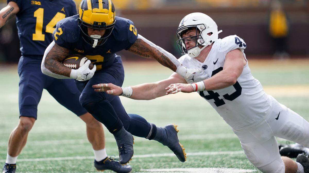 Michigan running back Blake Corum bounces off the tackle of Penn State linebacker Tyler Elsdon in the first half of Saturday’s game in Ann Arbor.
