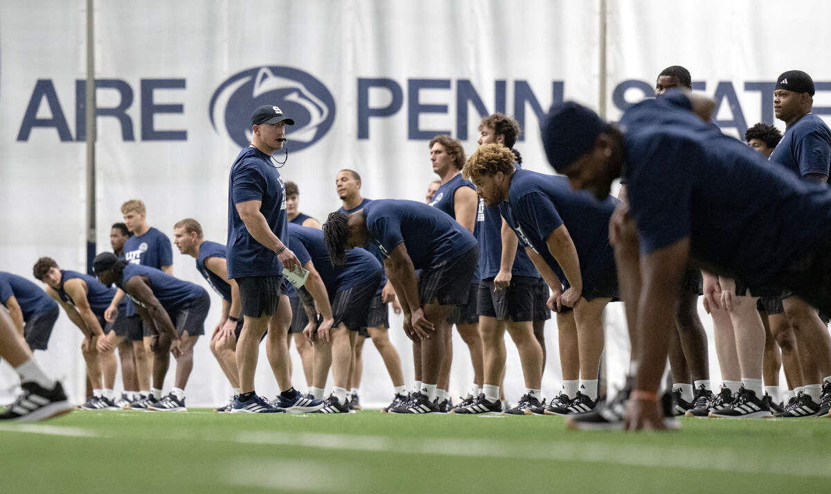 Penn State football strength and conditioning coach Reid Kagy watches players stretch for Lift For Life on Wednesday, July 1, 2026.