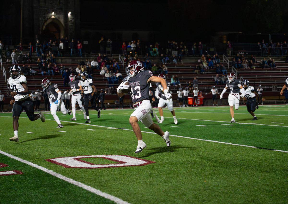 State College senior Hank Lustig (13) runs down the field during a Friday night football game against Central Dauphin East in State College, Pa., on Oct. 10, 2025. The Little Lions beat the Panthers 39-14.