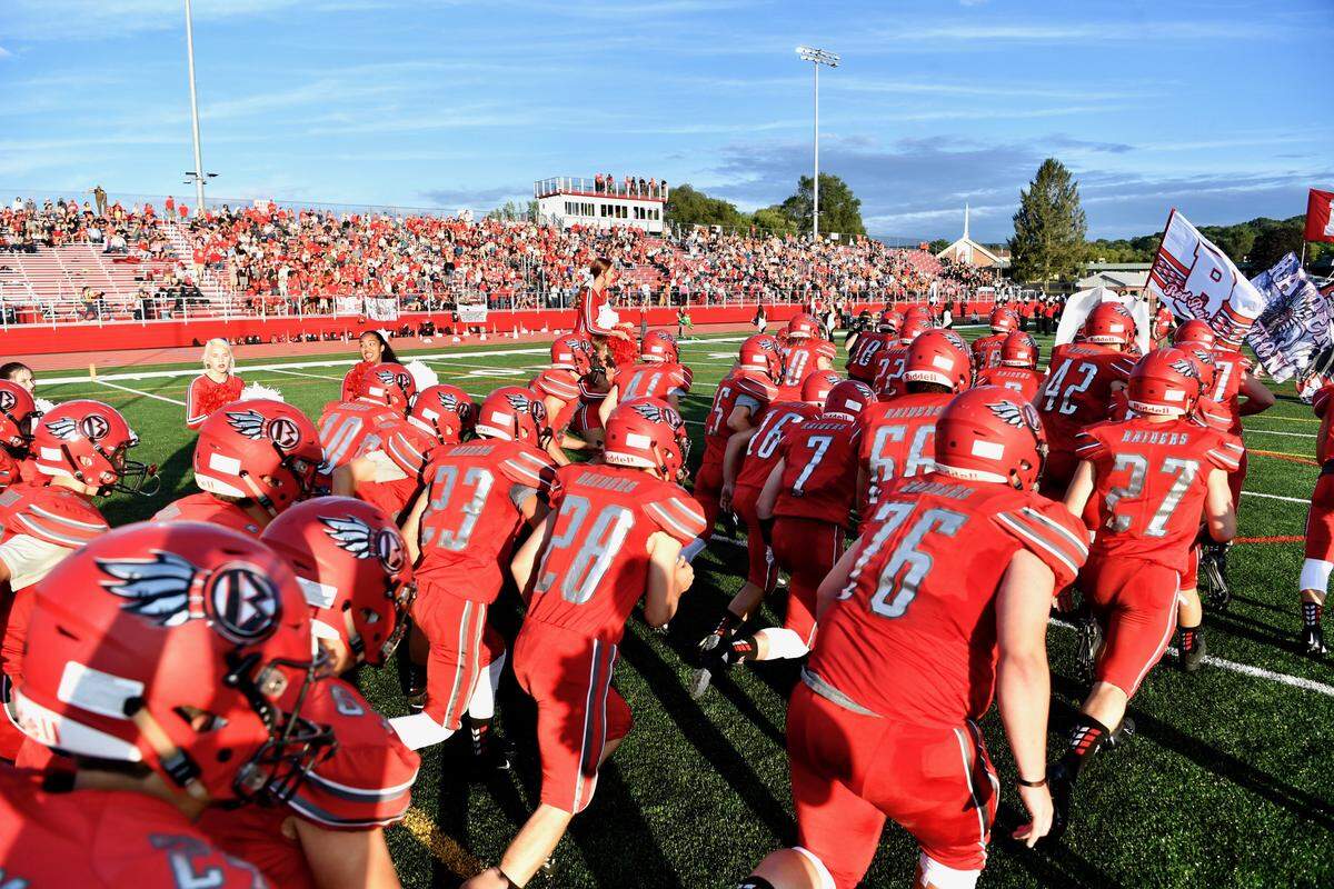 The Bellefonte Area High School football team runs onto the field at Rogers Stadium Friday evening. 