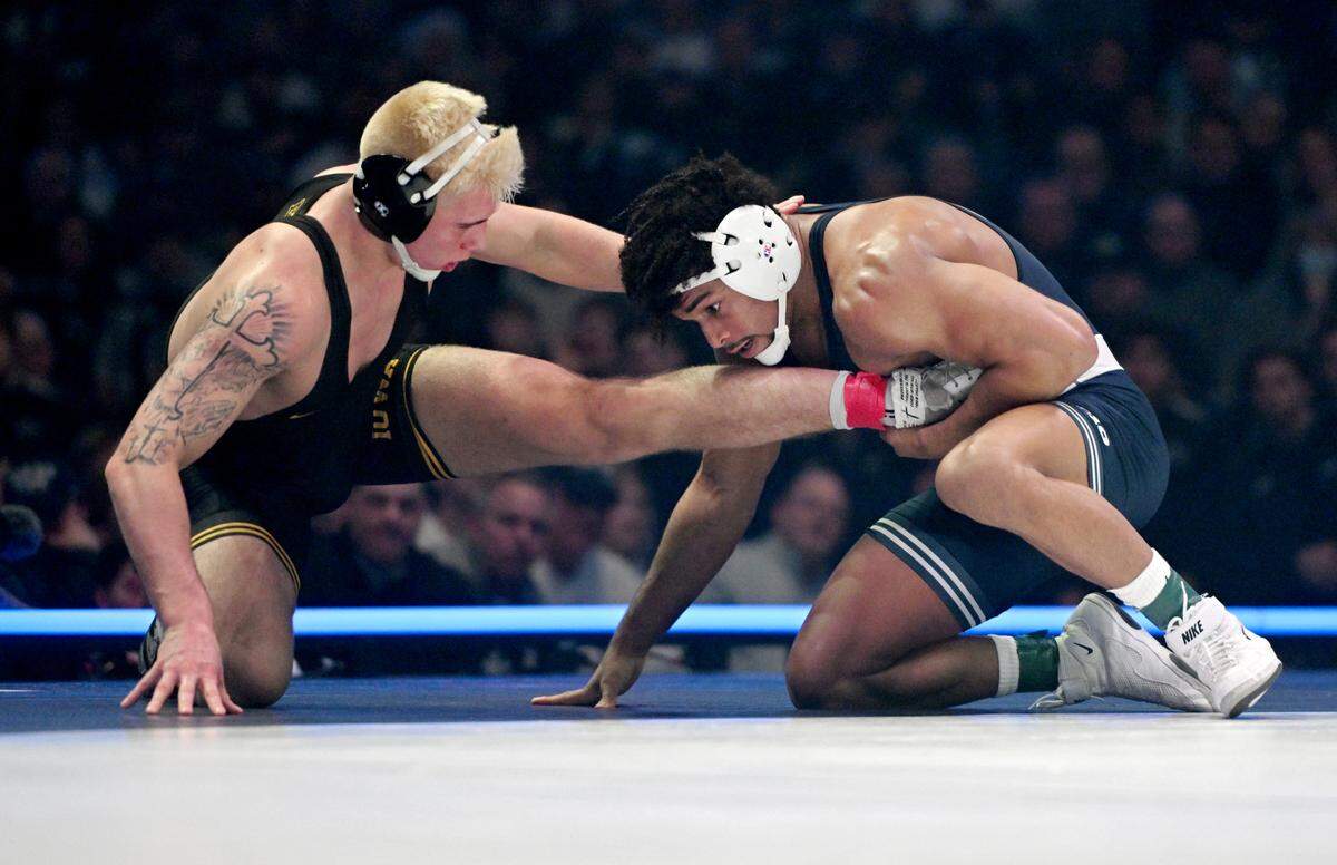 Penn State’s Carter Starocci pulls in Iowa’s Angelo Ferrari in the184 lb bout of the match on Friday, Jan. 31, 2025 at the Bryce Jordan Center. Starocci won by decision, 2-1.