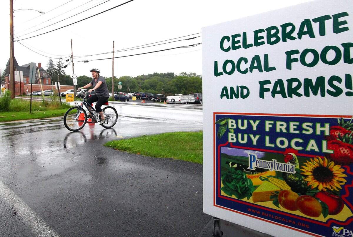 Deb Simpson of State College arrives for lunch across from the Millheim Fire Company during the Pennsylvania Association for Sustainable Agriculture's annual Bike Fresh Bike Local-Centre County on Sunday in Millheim.