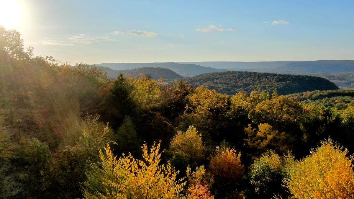 The sun sets as the colors of fall foliage start to pop from Bell’s Majestic View in Bald Eagle State Forest on Tuesday, Oct. 11, 2022. The autumnal equinox will occur Saturday, heralding the fall season.