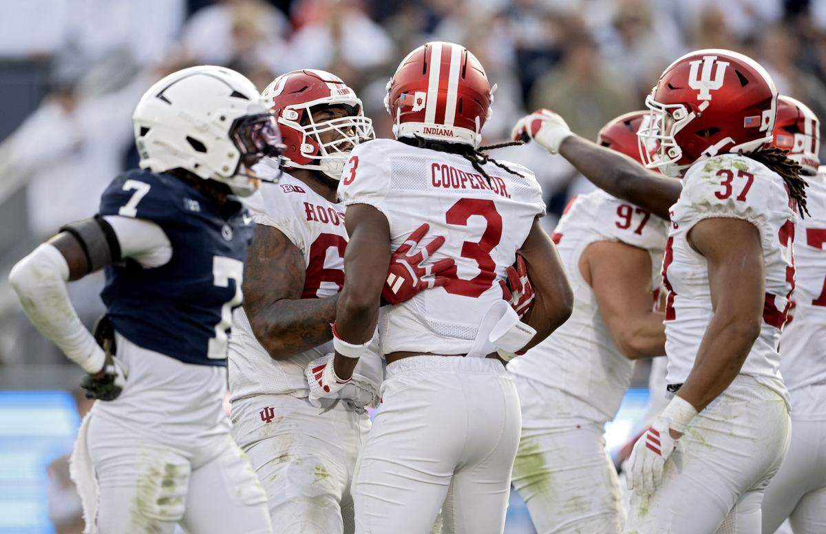 Indiana players celebrate a play in the fourth quarter as Penn State cornerback Zion Tracy walks by in disappointment on Saturday, Nov. 8, 2025.