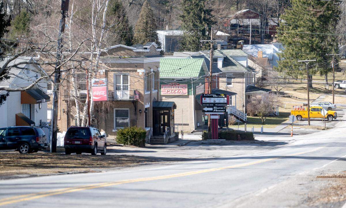 A look down East Olive Street in Snow Shoe Borough, where there is a Beer One, Laurel Optics and Brother’s Pizza on Thursday, Feb. 23, 2023.