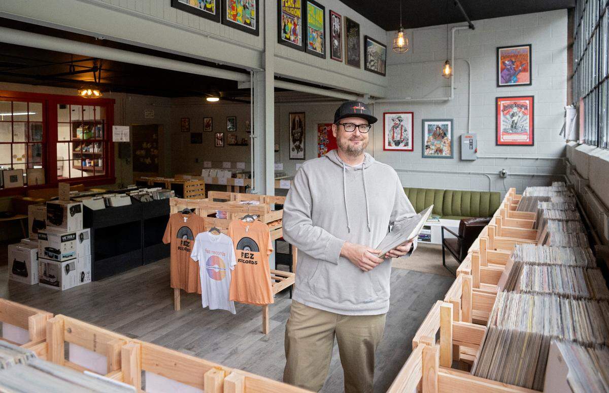Michael Fester holds several records in his new shop Fez Records in the Titan Energy Park on Thursday, Sept. 29, 2022.