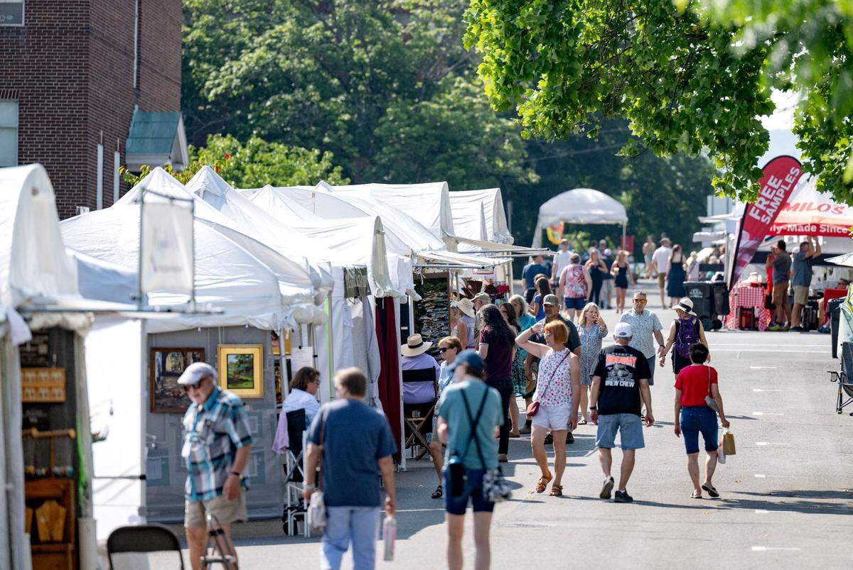 Vistors browse the booths along Fraser Street during the Central Pennsylvania Festival of the Arts on Friday, July 11, 2025.