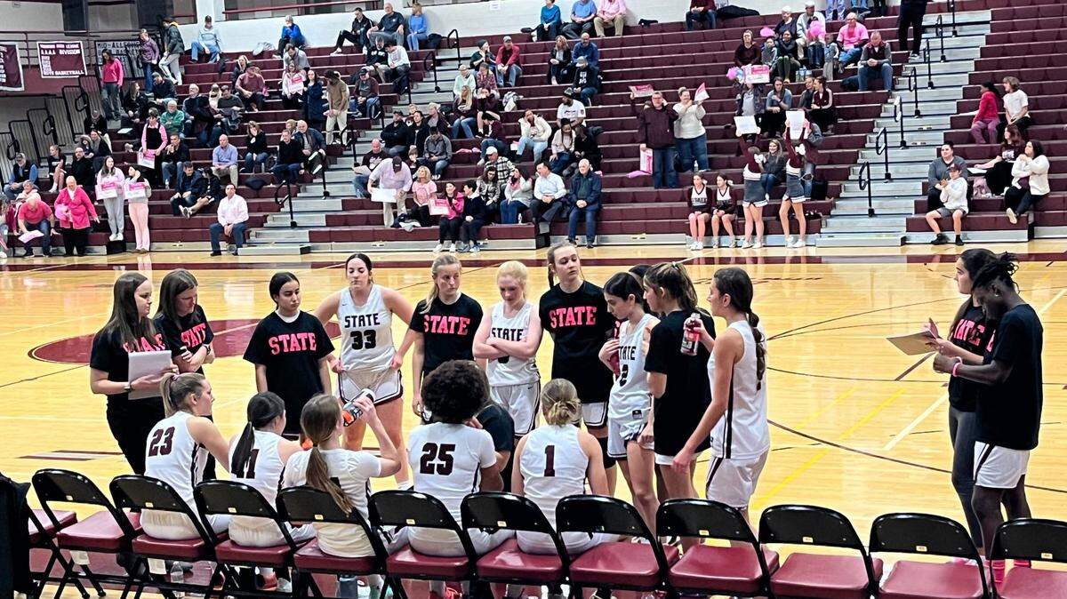 State College girls basketball wears black and pink breast cancer awareness shirts.