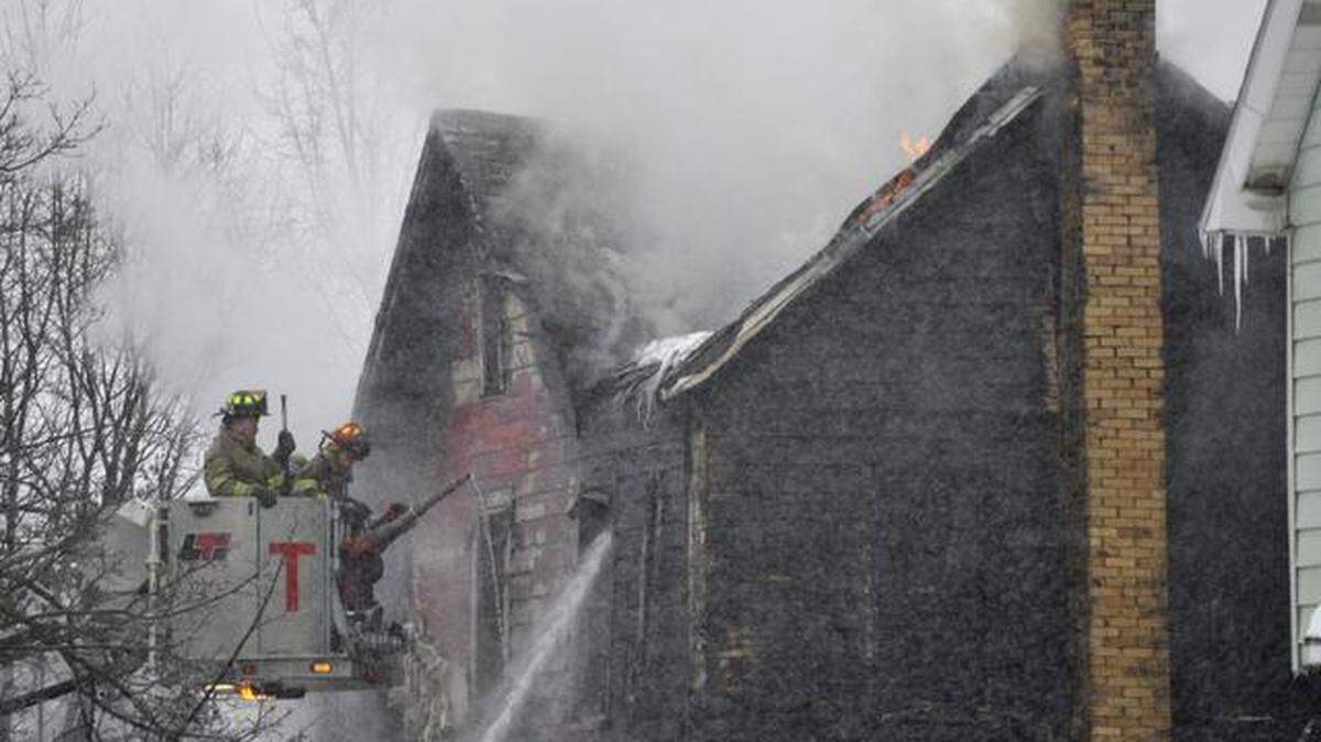 Firefighters work to extinguish a blaze at a home on Daisy Street in Clearfield, Pa. on Tuesday, March. 3, 2015.
