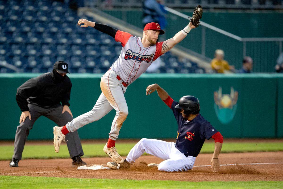 State College Spike’s Mael Zan safely slides to third as the Williamsport’s Kyle O’Brien reaches for the ball during the opening game on Monday, May 24, 2021.
