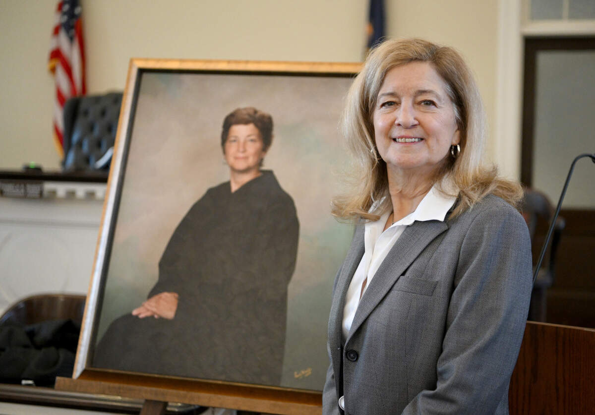 Centre County President Judge Pamela A. Ruest stands on Tuesday, Dec. 13, 2022, next to her portrait that will be hung in the Centre County Courthouse.