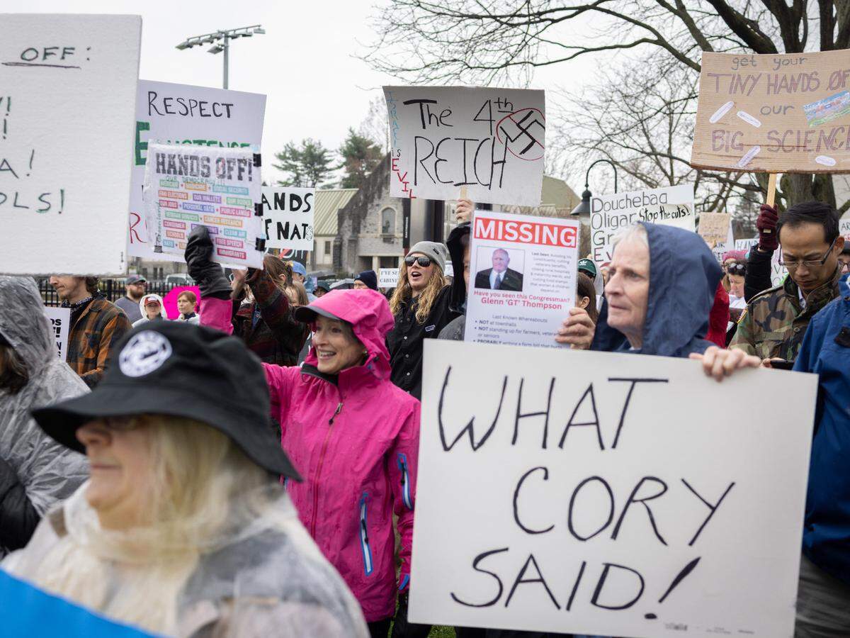 Protesters hold signs Saturday while listening to speakers at the “Hands Off!” rally at State College’s Sidney Friedman Park, in opposition of President Donald Trump. The event was part of a nationwide effort that saw more than 1,000 similar rallies held across all 50 states.