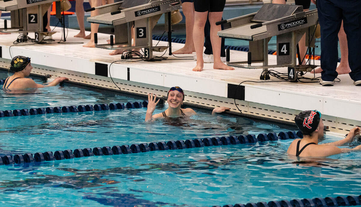 State College's Molly Workman holds up four fingers to signify her four gold medals won after anchoring the 400 freestyle relay during the PIAA Class 3A Swimming & Diving Championship at Kinney Natatorium in Lewisburg, Pa., Thursday, March 12, 2026. State College won with a time of 3:24.98.