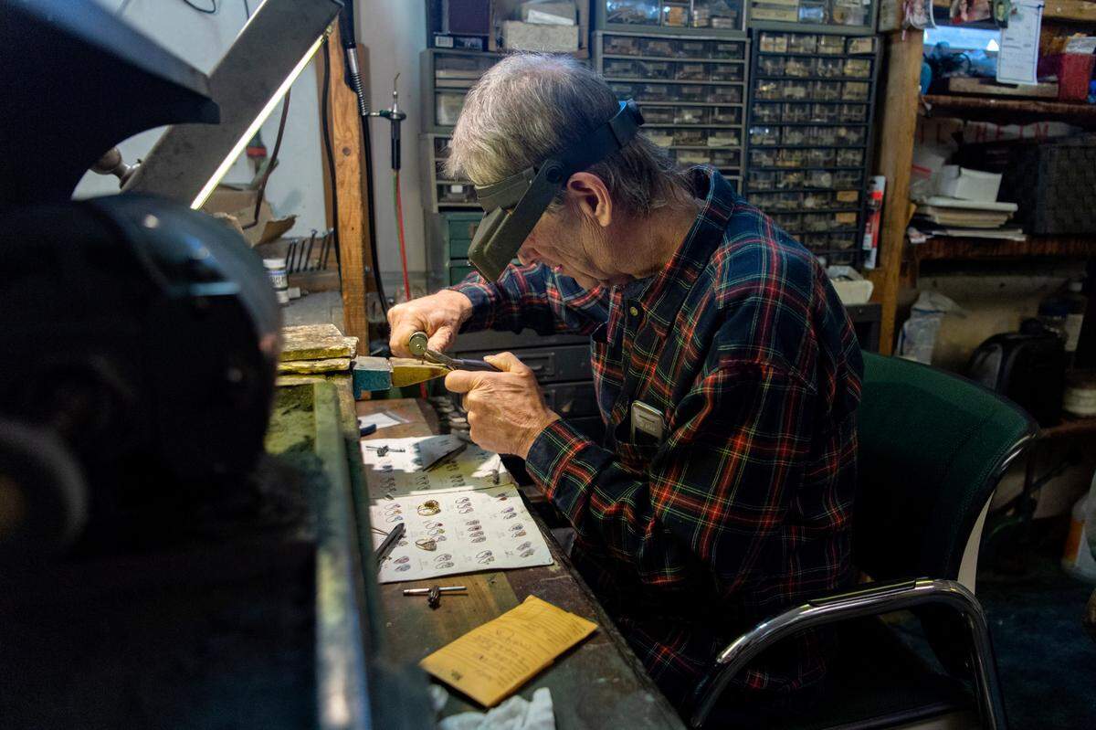 Richard Winebold works to enlarge a gold ring for a customer at Penns Valley Jewelers on Thursday, Dec. 16, 2021.
