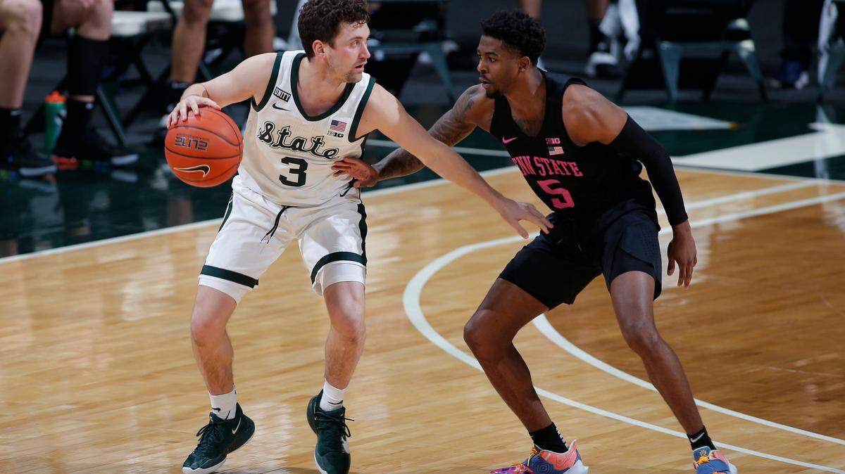 Michigan State’s Foster Loyer, left, controls the ball against Penn State’s Jamari Wheeler (5) during the first half of an NCAA college basketball game, Tuesday, Feb. 9, 2021, in East Lansing, Mich. (AP Photo/Al Goldis)