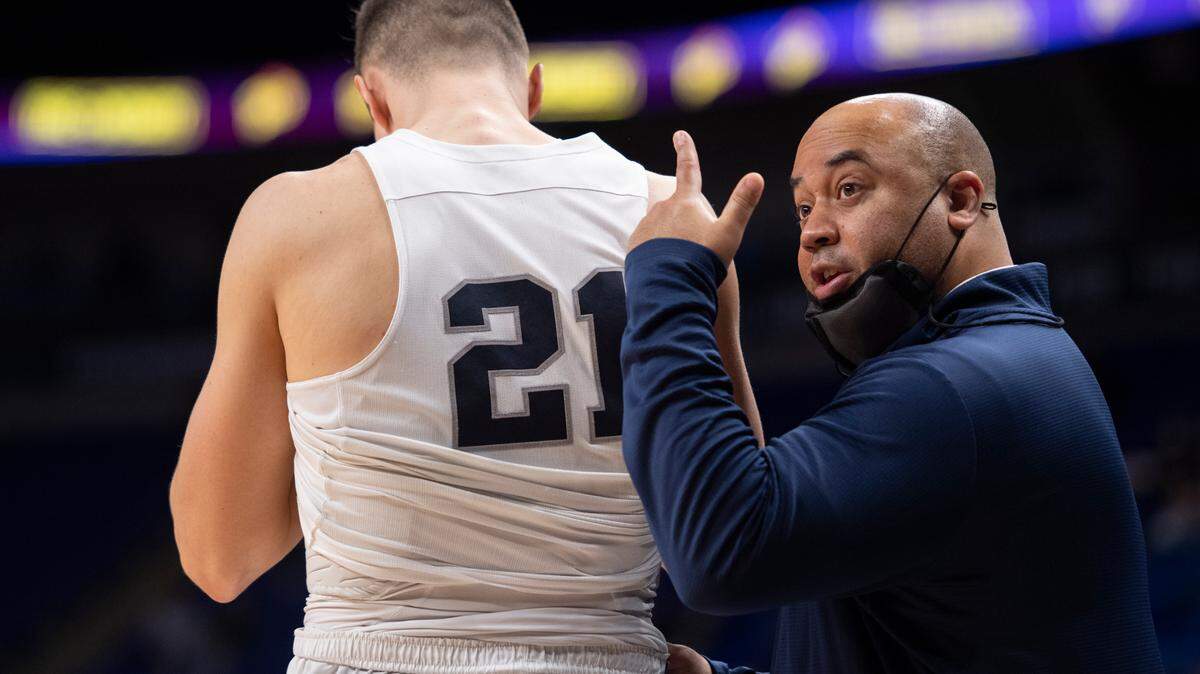 Penn State head coach Micah Shrewsberry walks Penn State forward John Harrar (21) to the midline for a substitution during an NCAA Basketball game between Penn State and Nebraska at the Bryce Jordan Center on Sunday, Feb. 27, 2022.