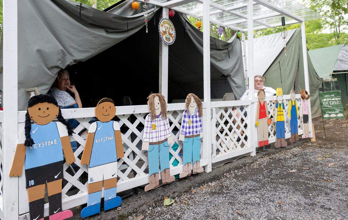 The Sharer’s family tent features wooden cutouts of the great grandchildren at the Centre County Grange Encampment and Fair on Monday, Aug. 19, 2024.