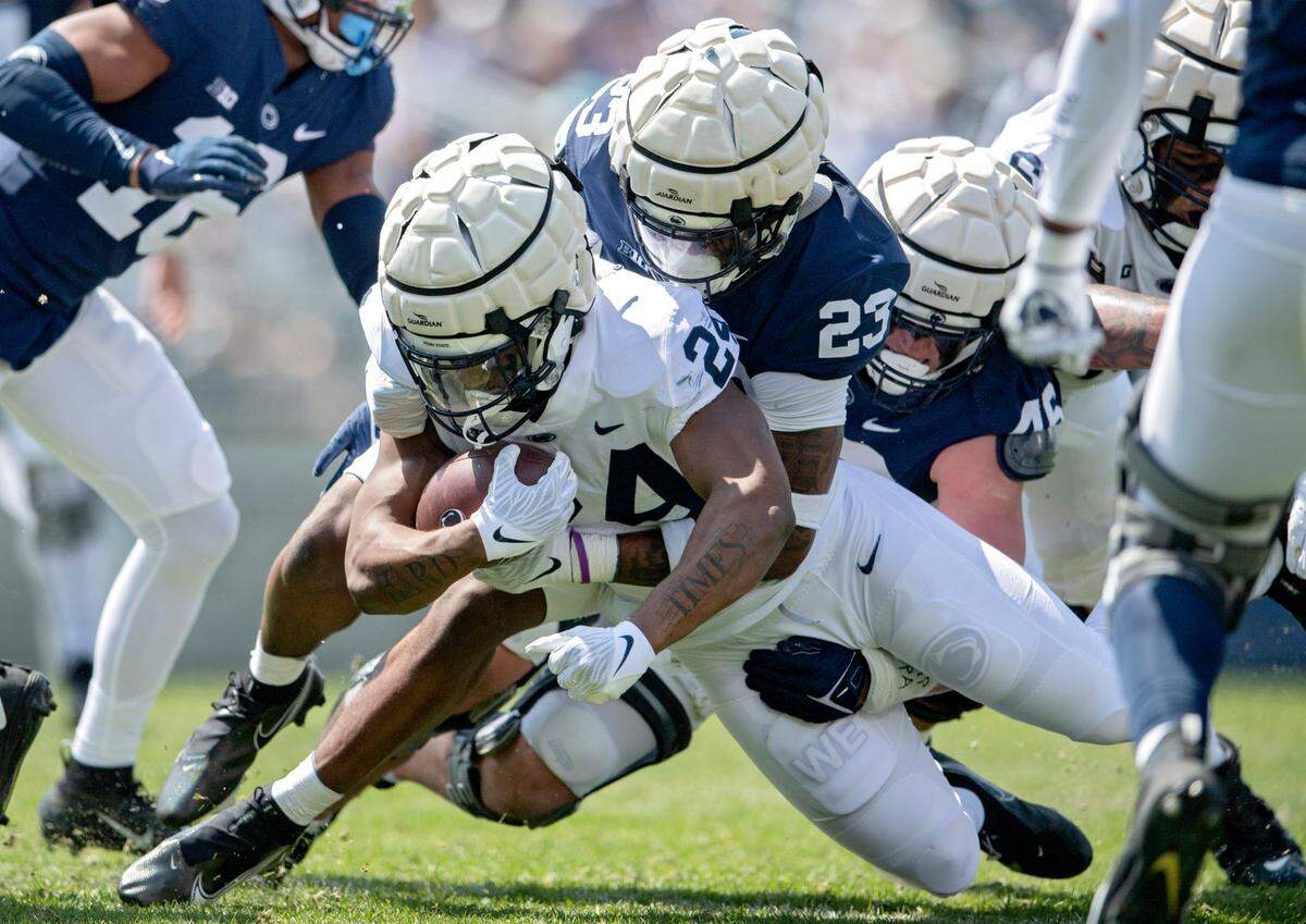 Penn State linebacker Curtis Jacobs stops running back Keyvone Lee during the Blue-White game on Saturday, April 23, 2022.