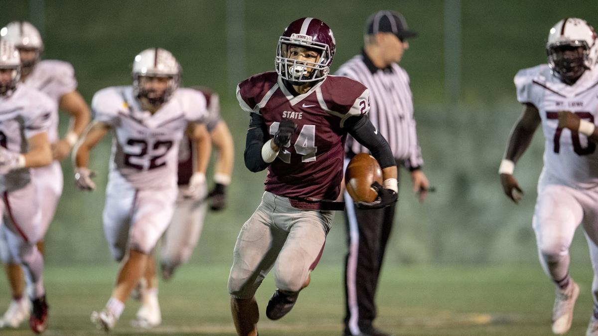 State College’s Dresyn Green runs from Altoona defenders for a touchdown during the game on Friday, Oct. 19, 2018 at Memorial Field.