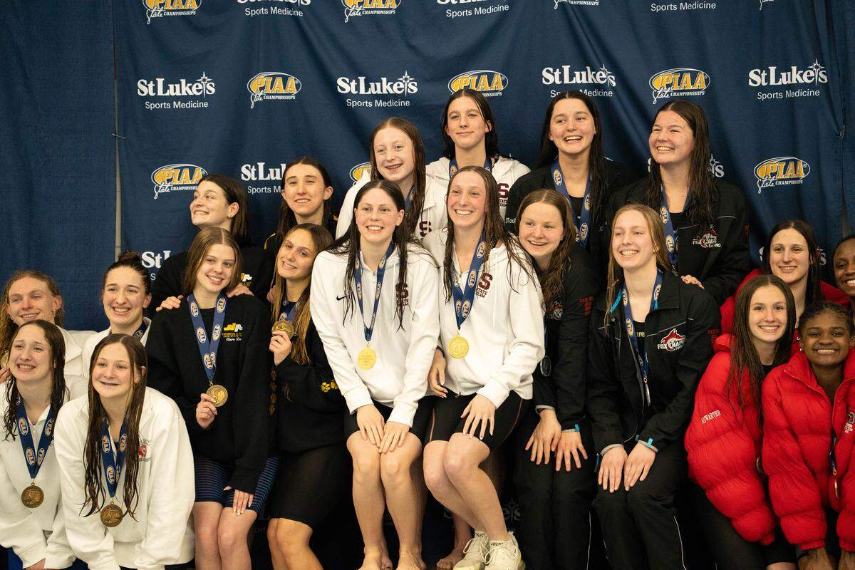 State College's Molly Workman, Isla Reite, Gabby Siekman and Ellen Woodruff, center, pose with their gold medals after winning the 400 freestyle relay during the PIAA Class 3A Swimming & Diving Championships at Kinney Natatorium in Lewisburg, Pa., Thursday, March 12, 2026. State College won with a time of 3:24.98.